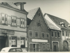 Exterior of three story building with peaked roof